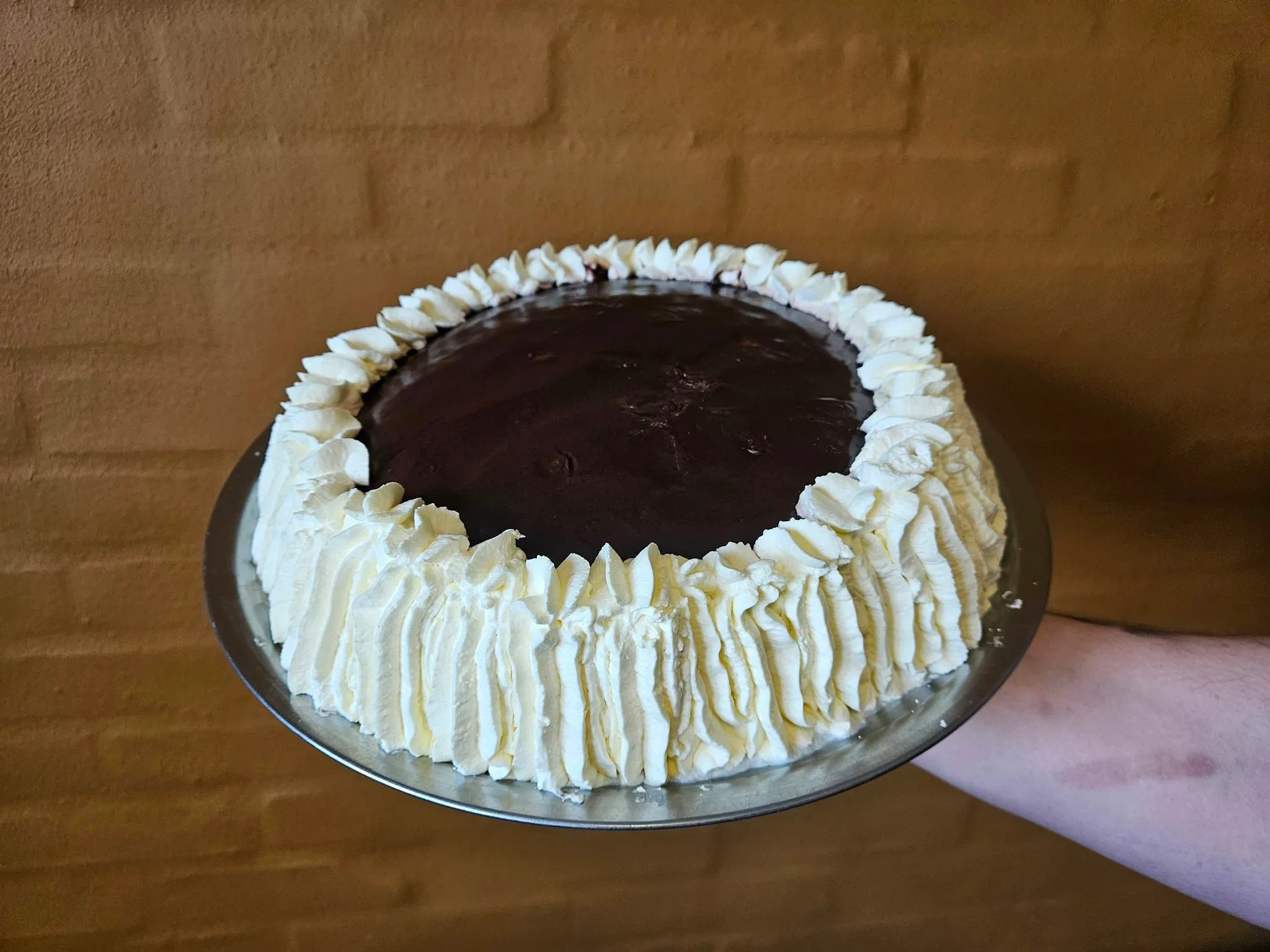 Chocolate cake with whipped cream decoration