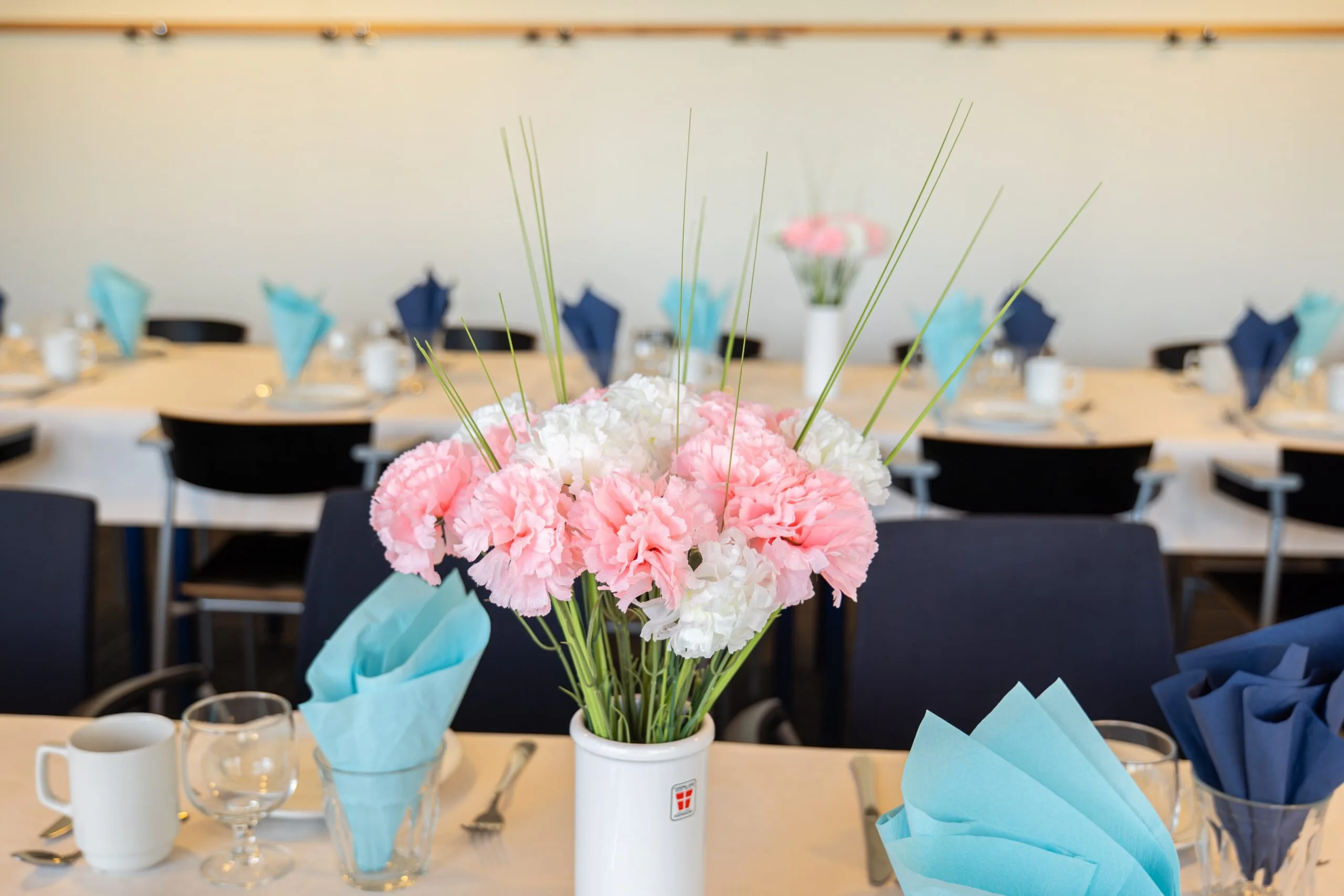 Pink and white flowers on decorated dining table
