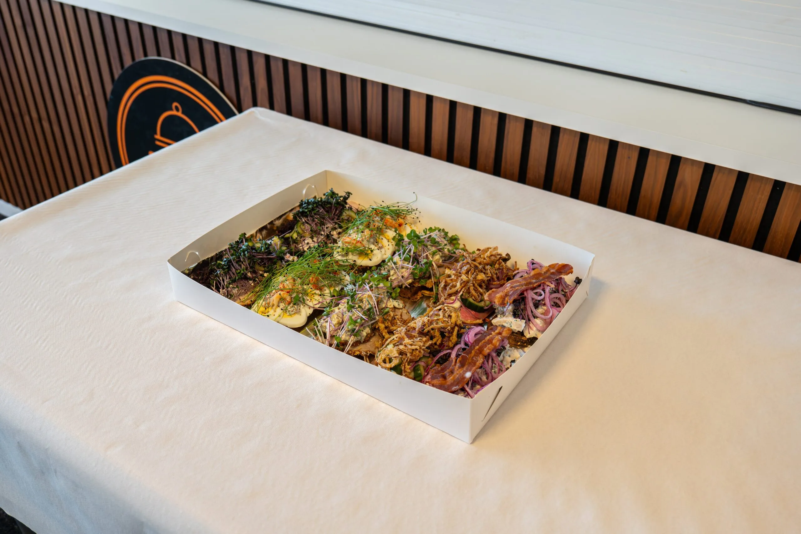 Assorted open-faced sandwiches in catering box